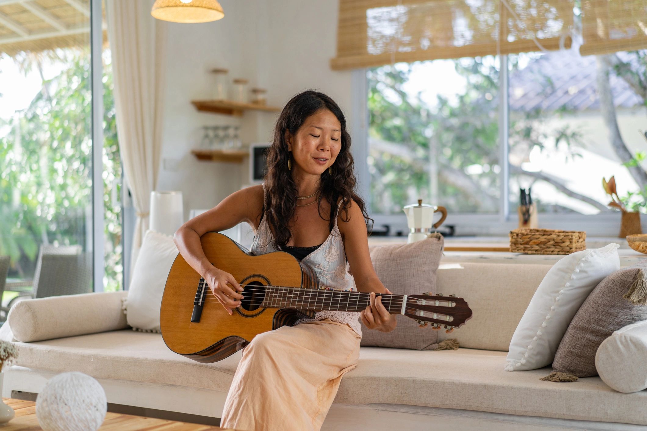 Musician playing guitar in studio setting