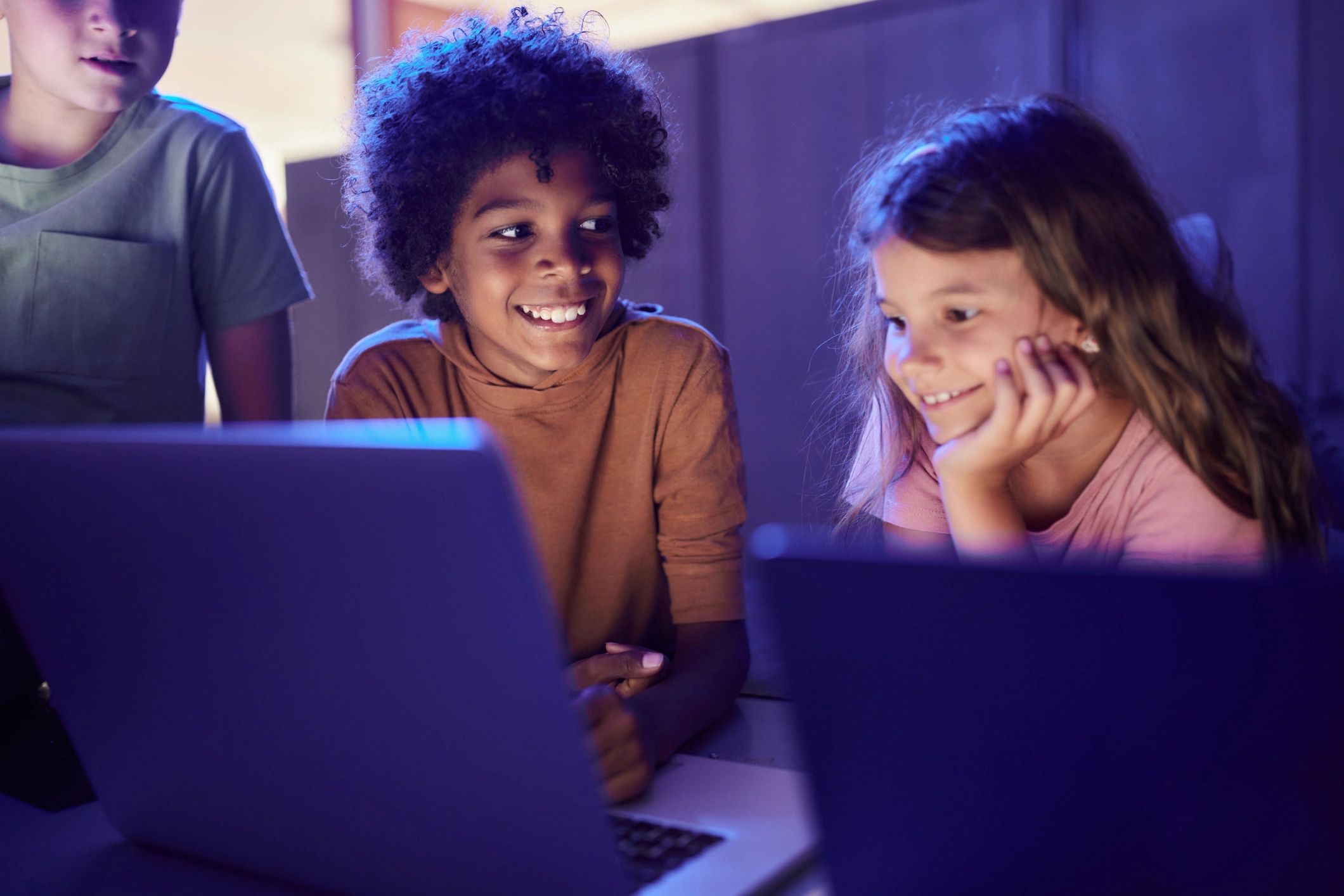 Children learning together on a computer